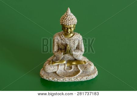 The Figure Of A Buddha On A Green Background