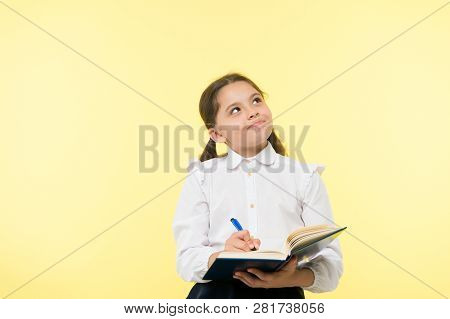 Child School Uniform Kid Doing Homework. Child Girl School Uniform Clothes Hold Book And Pen. Girl C