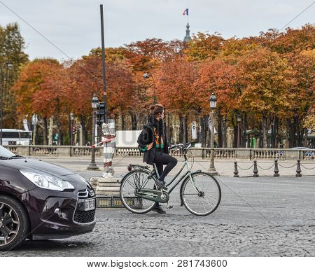 Woman Biking On Street Of Paris, France
