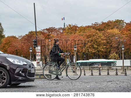 Woman Biking On Street Of Paris, France