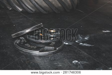 Bunch Of Heavy Black Barbell Weight Plates On The Gym Floor Prepared For Hard Core Fitness Workout S