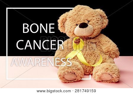 Yellow Ribbon Symbolic Color For Sarcoma Bone Cancer Awareness And Suicide Prevention With Toy Bear.