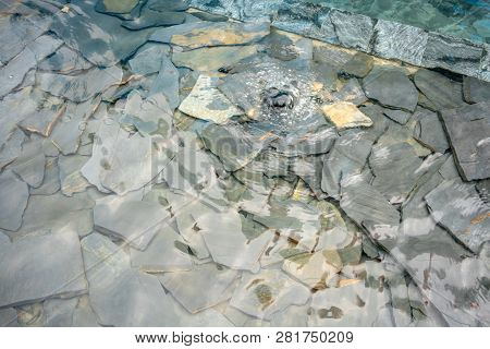 Decorative Fountain Water On Modern Rock Stone Crack Pieces. Ladnscape Design Detail.