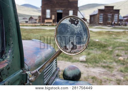 Focus On An Old Classic Rearview Mirror On A Classic Jalopy Truck, Abandoned In The Bodie Ghost Town