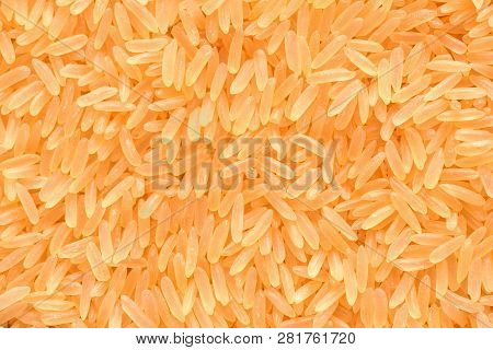 A Beautiful And Voluminous Long Rice, Raw, Not Cooked. Surface Of Rice Cerea. Yellow Rice Close-up