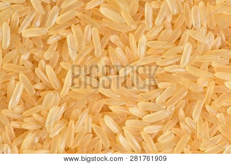 A Beautiful And Voluminous Long Rice, Raw, Not Cooked. Surface Of Rice Cerea. Yellow Rice Close-up