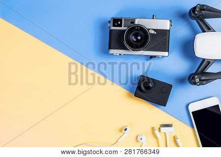 Hi Tech Travel Gadget And Accessories On Blue And Yellow Copy Space Top View Flat Lay