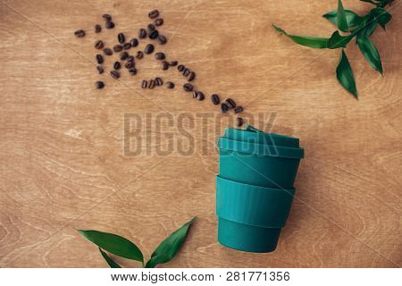 Zero Waste Concept, Flat Lay. Stylish Reusable Eco Coffee Cup  On Wooden Background With Coffee Bean