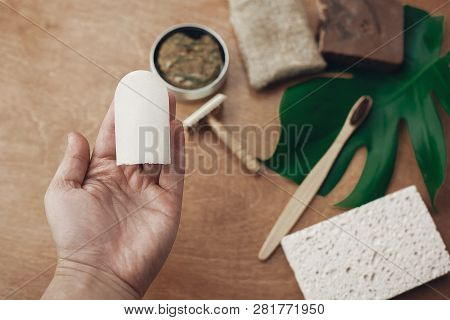Zero Waste Concept. Hand Holding Natural Eco Crystal Deodorant On Background Of Bamboo Toothbrush, S