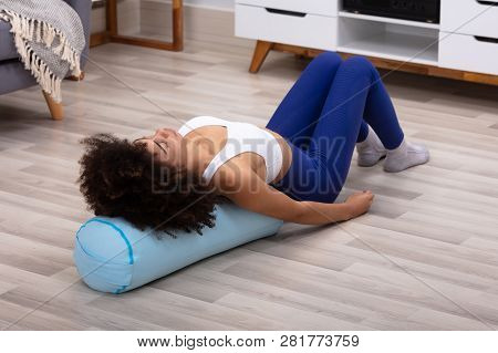 Close-up Of A Young African Woman Lying On Pillow Exercising
