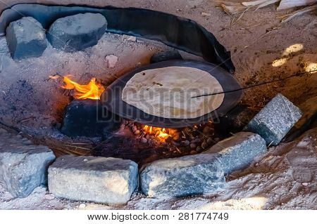 Pita Bread Cooking On Fire In Bedouin Dwelling