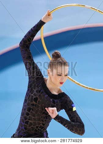 KIEV, UKRAINE - AUGUST 28, 2013: Alina Maksymenko, Ukraine performs with hoop during 32nd Rhythmic Gymnastics World Championships. Eventually she took 5th place