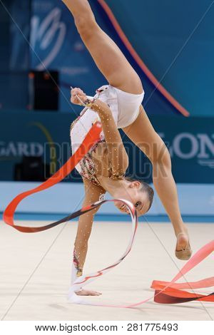 KIEV, UKRAINE - AUGUST 29, 2013: Lucille Chalopin, France performs with ribbon during 32nd Rhythmic Gymnastics World Championships. The event is held in Palace of Sport
