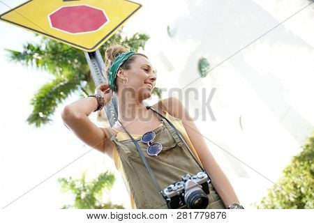 Stylish young woman with vintage camera in urban setting