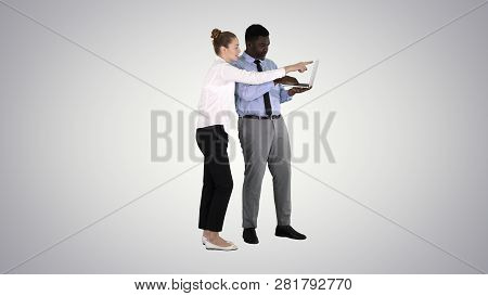 Afro American Business Adviser Showing Something On Laptop Screen Talking To Gradient Businesswoman 