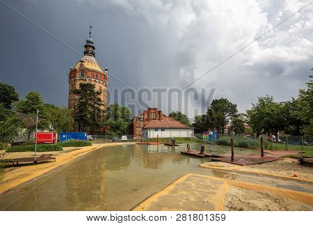Public Park And Playground For Children Wasserspielplatz In Front Of The Historic Water Tower Wasser