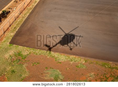 Shadow Of Small Hughes Helicopter Landing At Lihue In Kauai
