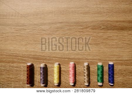 The Coils Of Threads Put On Wooden Table