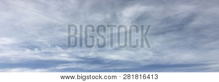 Beautiful Snowy Clouds Against A Blue Sky Background. Sky Cloud. Blue Sky With Winter Clouds Weather