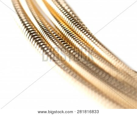 Strings For Guitar Isolated On A White Background. Macro