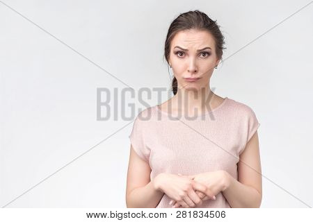 Woman Holding Hands On Her Chest And Looking Uat Camera With Eyes Full Of Hope
