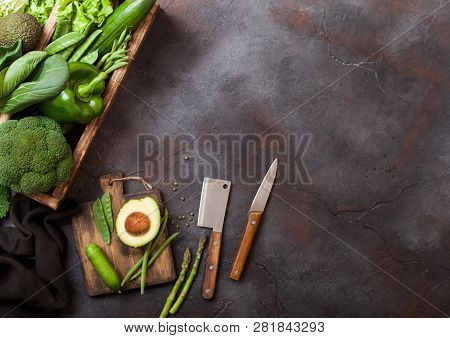 Assorted Green Toned Raw Organic Vegetables In Wooden Box On Dark Stone Background. Avocado, Cabbage
