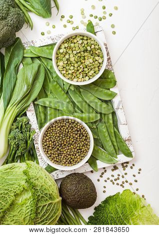 Assorted Green Toned Raw Organic Vegetables On White Background. Avocado, Cabbage, Broccoli, Caulifl