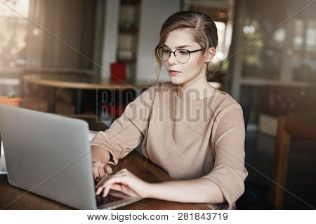 Girl Knows How Manage Worktime. Studio Shot Of Attractive Serious European Female In Glasses And Off