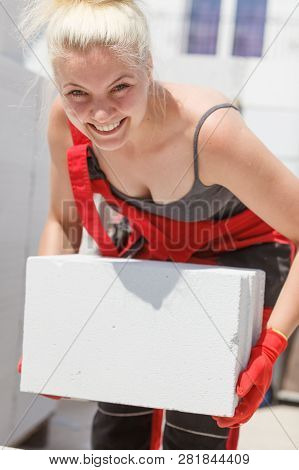 Strong Pretty Woman Working On Construction Site, Building House, Installing Gray Airbricks. Industr