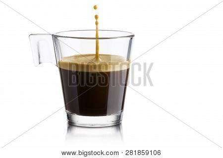 Black Coffee In Glass Cup With Jumping Drop On White Background