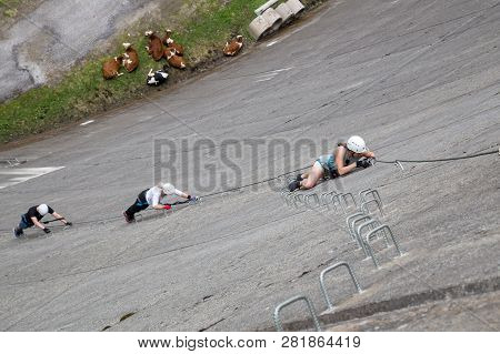 Finkenberg, Austria - June 9, 2018: Group Of Alpinists Climbing The Via Ferrata On The Schlegeis Dam