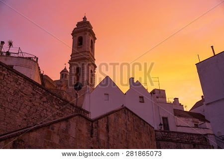 Scenic Orange Susnet And Oldtown Buildings In Locorotondo, Region Puglia, Italy