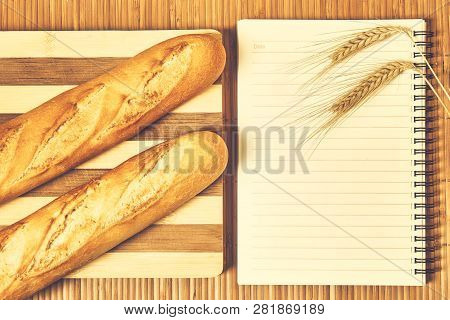 Baguettes And Notebook On The Table
