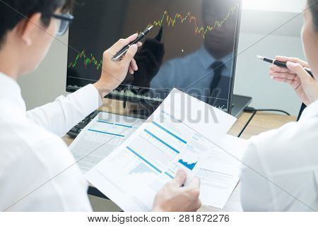 Team Investment Entrepreneur Discussing And Analysis Forex Trading Charts And Graphs On Computer Scr
