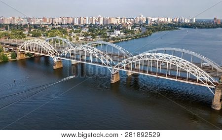Aerial Top View Of Automobile And Railroad Darnitsky Bridge Across Dnieper River From Above, Kiev (k