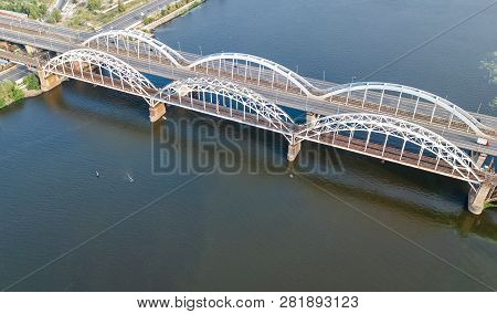 Aerial Top View Of Automobile And Railroad Darnitsky Bridge Across Dnieper River From Above, Kiev (k