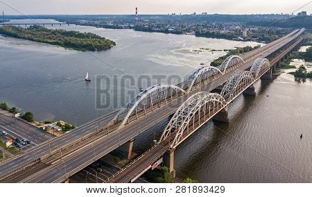Aerial Top View Of Automobile And Railroad Darnitsky Bridge Across Dnieper River From Above, Kiev (k