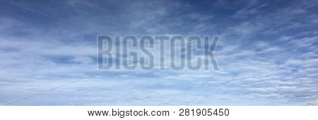 Beautiful Snowy Clouds Against A Blue Sky Background. Sky Cloud. Blue Sky With Winter Clouds Weather