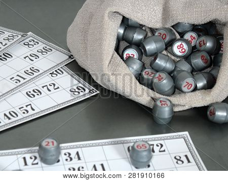 Cards And Kegs From A Lotto Board Game On A Gray Table