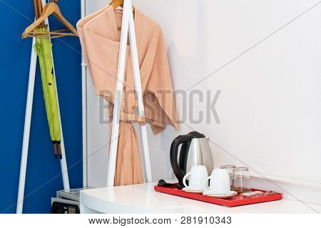 Hotl Bedroom With Cup Of Coffee And Plain Background.