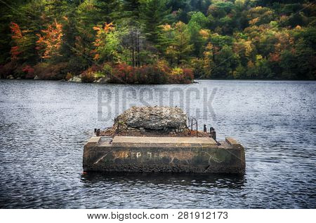 The Green And Changing Colors Trees Reflecting Off Of The Waters In Burr State Park In Torrington, C