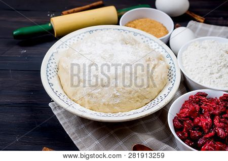 Raw Dough In A Bowl And Ingredients For Making Cake  - Flour, Egg, Cherry, Brown Sugar, Cinamon On T