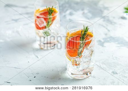Alcoholic Cocktail With Grapefruit, Soda, Ice, Gin And Rosemary