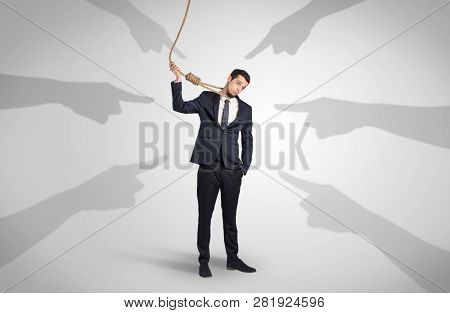 Young businessman trying to suicide with pointing hands concept