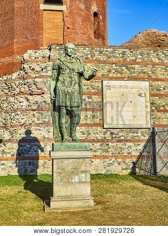 Gaius Julius Caesar Statue In Front Of Porta Palatina Gate. Piazza Cesare Augusto Square. Turin, Pie