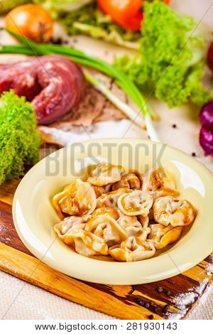 Dumplings With Meat In Beige Plate On Wooden Board. Russian Cuisine