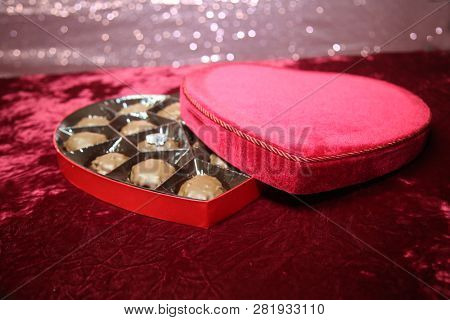 Engagement Ring. Wedding Ring or Engagement Ring with Chocolates in a Red Velvet Valentines Day Heart Shaped Box. Marriage Proposal. Will you Marry Me?. Room for text. 
