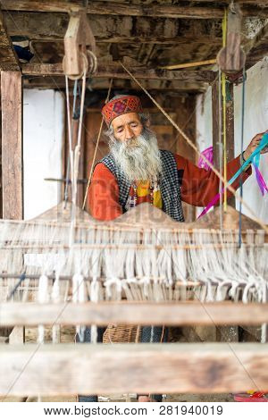 Kullu, Himachal Pradesh, India - August 09, 2018 : An Indian Old Man Makes A Traditional Sadu Weavin
