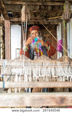 Kullu, Himachal Pradesh, India - August 09, 2018 : An Indian Old Man Makes A Traditional Sadu Weavin