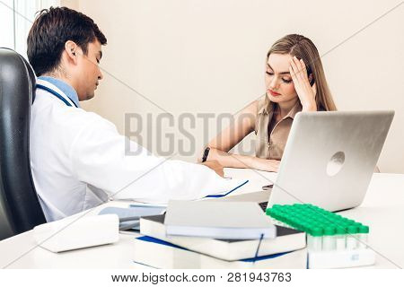 Doctor Discussing And Consulting With Female Patien On Doctors Table In Hospital.healthcare And Medi